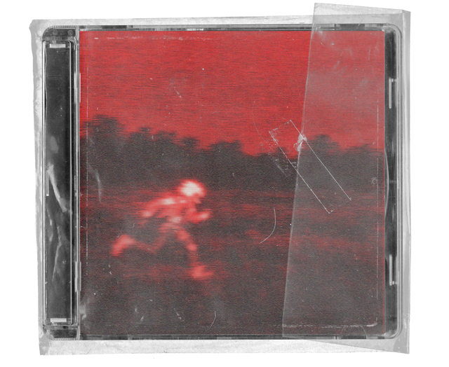CD jewel case in clear shrink wrap. The cover is a blurred, red-tinted photograph of a small figure running across a field at dusk, with a strip of clear tape across the wrap.