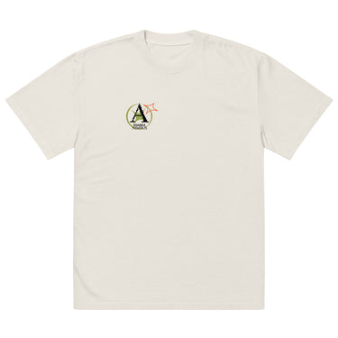 Front view of a solid-colored oversized-tee. A small graphic on the left chest features a circular emblem containing a large, pixel-art style letter 'A'. A small, outlined star symbol is next to the emblem.