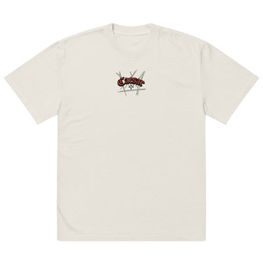 Front view of a solid-colored, oversized-tee. A small graphic is centered on the chest, featuring the word "Caesar" in a stylized script font, layered over a background of sketchy, crisscrossing lines.