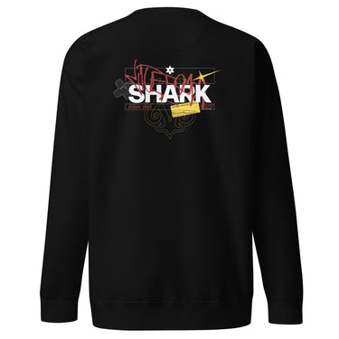 Back view of a solid-colored sweatshirt. A large, chaotic collage graphic on the upper back features the word "SHARK" in a bold font. The design is layered with various handwritten signatures, sketchy scribbles, and abstract background patterns.