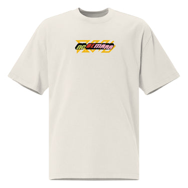 Front view of a solid-colored oversized-tee. A small, horizontal graphic on the chest features the stylized text "NC DEMARA" filled with a high-contrast, diagonal stripe pattern.