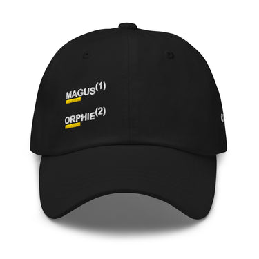 Black baseball cap, front view, showing embroidered black text 'MAGUS(1)' and 'ORPHIE(2)' stacked vertically with bold yellow underlines, visible distressed details on brim and panels.
