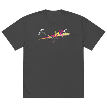 Front view of a solid-colored oversized-tee. A large, dynamic graphic across the chest features a chaotic collage of high-contrast brush strokes, sharp angular forms, and silhouettes resembling swooping birds.