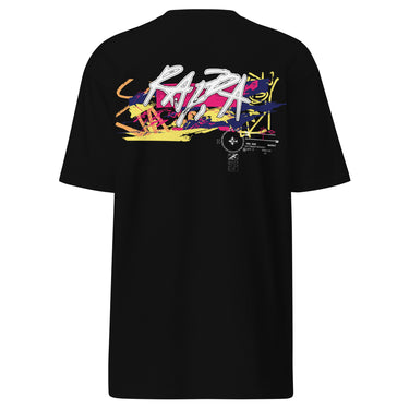 Back view of a solid-colored shirt. A large, horizontal graphic on the upper back features a stylized, graffiti-like word spelling “RAPPA” layered over a wide smear of high-contrast brush strokes imitating graffiti splatter. To the side are smaller, schematic graphics including a compass rose and blocks of text.