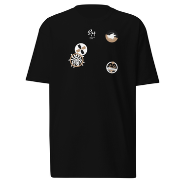 Front view of a solid-colored shirt. The chest features a small signature and four different circular emblems, each containing a unique high-contrast, abstract pattern.