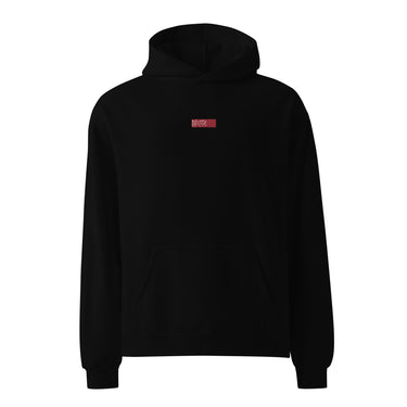 Front view of an oversized hoodie in black. Design is a small, embroidered red patch on the left chest featuring the white line art of an Astral Express ticket from Honkai: Star Rail.
