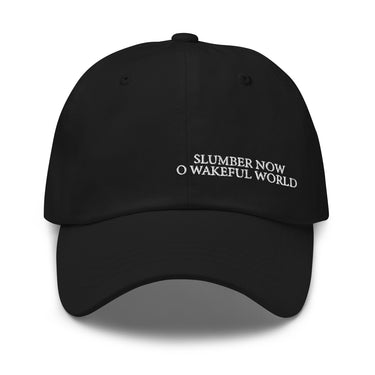 Front view of an baseball cap in black. Evernight inspired design, shows off-centered embroidered text leaning right that reads “SLUMBER NOW O WAKEFUL WORLD.”