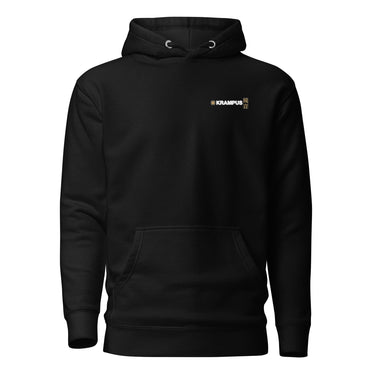 Front view of an hoodie in black. A minimalist design placed on the upper left chest shows a compact arrangement of small graphic elements, including a circular icon, the word “KRAMPUS” in bold, and a narrow vertical block with stylized symbols.