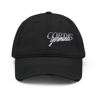 Front view of an distressed hat in black. Design is with embroidered text centered above the brim. The stitching combines serif and script styles, reading “Cordis Germina.”