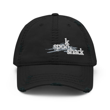 Front view of an distressed hat in black. It features an embroidered logo with the words "spook shack" in a stylized, stacked font, layered over abstract horizontal brush strokes.