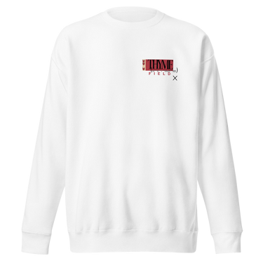 A white crewneck sweatshirt with an off centered graphic to the left side of the sweatshirt. The design features the word 'THYME' in a large, black font layered over a red rectangle accompanied by red text depicting "FIELD" underneath it.
