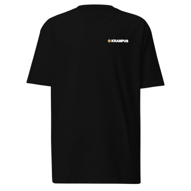 Front view of an t-shirt in black. A minimalist design is placed on the upper left chest, featuring a compact arrangement of graphic elements. The word “KRAMPUS” appears in small white uppercase lettering, paired with a circular gold icon to its left.