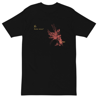 Front view of a solid-colored shirt. A graphic on the chest features a large, abstract, high-contrast shape resembling a flower, accompanied by several lines of handwritten-style script.
