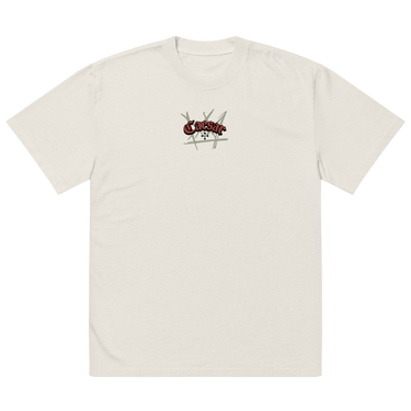 Front view of a solid-colored, oversized-tee. A small graphic is centered on the chest, featuring the word "Caesar" in a stylized script font, layered over a background of sketchy, crisscrossing lines.