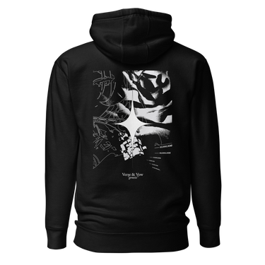 Back view of an hoodie in black. The design showcases a large, intricate graphic centered on the upper back. A radiant, four-point star form sits in the middle, surrounded by fragmented abstract shapes, and faint technical linework. Scattered numbers and coordinates appear along the right side, adding a coded, data-driven atmosphere. At the bottom of the composition, serif text reads “Verse & Vow,” followed by the word “genesis” in delicate handwritten script.
