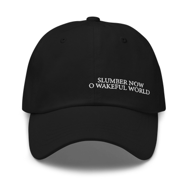 Front view of an baseball cap in black. Evernight inspired design, shows off-centered embroidered text leaning right that reads “SLUMBER NOW O WAKEFUL WORLD.”