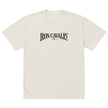 Front view of a solid-colored oversized-tee. A graphic centered on the chest features the words "IRON CAVALRY" in an elegant, arched serif font, with a small icon of two mirrored axe heads in the center.