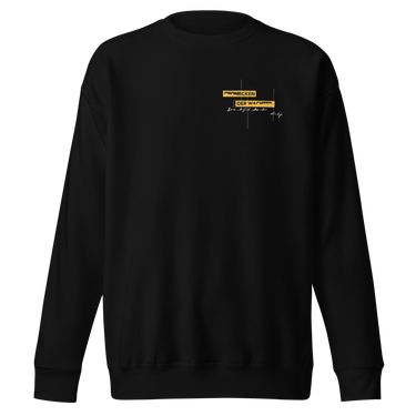 Front view of an sweatshirt in black. Design is positioned on the upper left chest. Design features a yellow rectangular label reading “CONNECKEN,” smaller text “DER WÄCHTER,” and fine white script lines and coordinates below it.