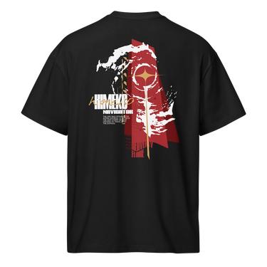 Back view of a Box Tee in Black. a large back graphic centered on a jagged, torn-map style emblem in white with a glowing star burst at its center, layered over angled orange-red geometric panels resembling sail or flag fragments, alongside a bold two-line wordmark, a short block of descriptive text, and a smaller diagonal wordmark near the hem