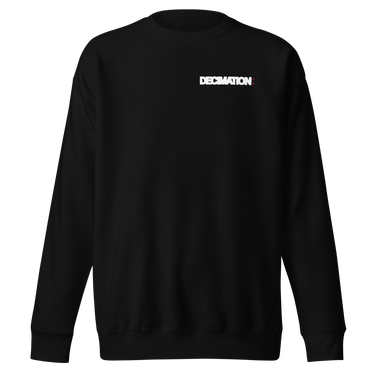 Front view of a sweatshirt in black. A bold 'DECIMATION' wordmark sits on the left chest in crisp white type, with a small red sparkle accent stamped beside it.