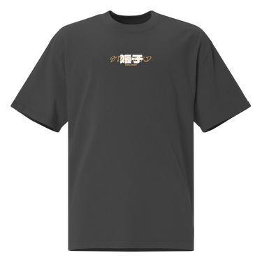 Front view of a Oversized Tee in Faded Black. a small chest graphic pairing a gold cursive wordmark partially overlaid by a bold white stylized emblem, with a block-letter word underneath in the same gold tone