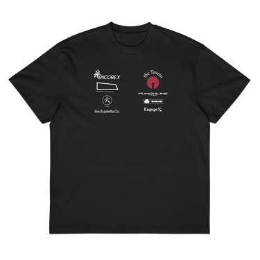 Front view of a box tee in black, flat. A graphic-forward arrangement of stylized sponsor-style logos fills the upper chest in two columns — featuring marks reading "ENCORE X," "the Tavern," "PUNCHLINE Tuning," "blocked. media management," "lies & palette Co.," "144," and "Engage," alongside a circular flame emblem. White and deep crimson lettering on black, blending streetwear with motorsport aesthetics.