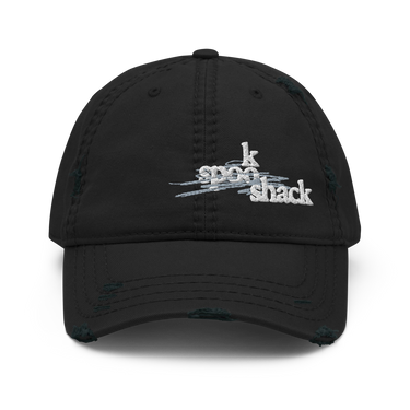 Front view of an distressed hat in black. It features an embroidered logo with the words "spook shack" in a stylized, stacked font, layered over abstract horizontal brush strokes.