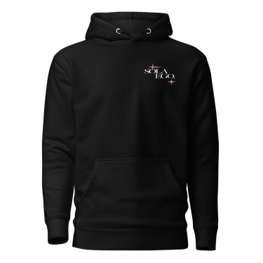 Front view of a hoodie in black. A small left-chest graphic reads 'SOLA EGO' in a high-contrast serif, split across two lines, with two four-pointed star accents in dusty pink flanking the type.