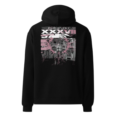 Back view of an oversized hoodie in black. A large rectangular back graphic layers an ornate hall interior in high-contrast greyscale beneath oversized roman numerals 'XXXVII' and a serif 'IN SILENTIO' wordmark. Dusty pink text bars carry a short poem down the left edge, cut through by thorned starburst linework in the same pink.