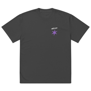 Front view of an oversized tee in faded black. A small graphic sits high on the left chest: a loose, hand-drawn halo ring in white tilted above a sharp six-pointed star in soft violet. Both shapes print flat, the ring's brushed edges left rough and unfinished.
