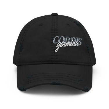Front view of an distressed hat in black. Design is with embroidered text centered above the brim. The stitching combines serif and script styles, reading “Cordis Germina.”