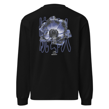 Back view of an longsleeve in black. A detailed blue-toned flower with soft gradients of indigo, slate blue, and muted lavender. Overlaid on the flower is stacked text reading “DO YOU REMEMBER / STEP FORTH INTO THESE GENTLE FLAMES / I AM YOUR MEMORY.” Behind the flower, abstract vertical line shapes in a muted bluish-purple create depth and contrast without overpowering the main illustration.