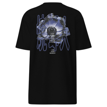 Back view of an t-shirt in black. A detailed blue-toned flower with soft gradients of indigo, slate blue, and muted lavender. Overlaid on the flower is stacked text reading “DO YOU REMEMBER / STEP FORTH INTO THESE GENTLE FLAMES / I AM YOUR MEMORY.” Behind the flower, abstract vertical line shapes in a muted bluish-purple create depth and contrast without overpowering the main illustration.