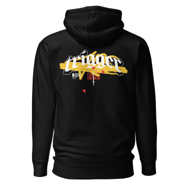 Back view of a solid-colored, hoodie. A large, horizontal graphic on the upper back features the word "trigger" in a high-contrast, graffiti, streetwear-style font. This is layered over a wide brushstroke shape and several smaller text elements, including a barcode and a cross symbol.