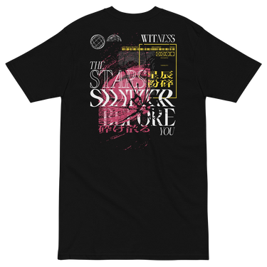 Back view of a solid-colored shirt. A large, complex collage graphic on the upper back features the text "THE STARS SHATTER BEFORE YOU" in a distressed style. The design is layered with abstract textures, barcodes, wireframe globes, and a web of lines creating a shattered glass effect.