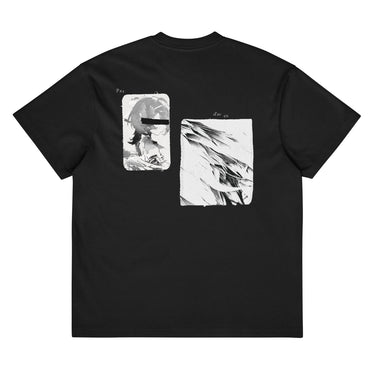 Back view of a box tee in black. A large two-panel composition fills the back. On the left, a halftoned portrait with a solid black bar across the eyes; to the right, a wider panel of sweeping feathers in heavy contrast. The words "pas" and "d'aveu" float above them in a fine serif, the letters spaced apart and drifting.