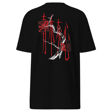 Back view of a tee in black. Four large vermillion brushstroke characters reading "春木灰心" run vertically down the center, layered with a stark white-and-red painterly tree branch winding through them. Two crimson rectangles bracket smaller ink motifs in the upper-left and lower-right, giving the composition an expressive, calligraphic, graphic-forward feel.