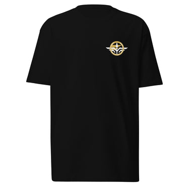 Front view of a t-shirt in Black. A small circular emblem sits on the left chest: a gold ring lettered "MIRACULUM IN CAELO NUMQUAM CADET" in white capitals, with a white winged spearhead standing through its centre and swept wings running out to either side.
