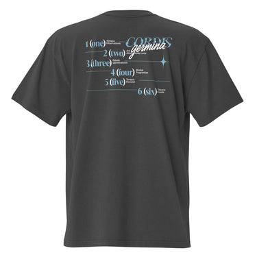 Back view of an oversized tee in black. Design is a structured typographic design across the upper back. The composition features a numbered sequence from one to six, each paired with Latin or pseudo-Latin text. The layout is horizontal with thin dividing lines and varied type treatments, creating a grid-like visual system.