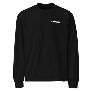 Front view of an longsleeve in black. A minimalist design is placed on the upper left chest, featuring a compact arrangement of graphic elements. The word “KRAMPUS” appears in small white uppercase lettering, paired with a circular gold icon to its left.
