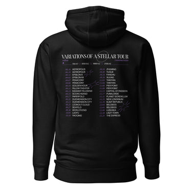 Back view of a hoodie in black. A large graphic fills the upper back, laid out like a concert tour poster. A wide display serif title reads "VARIATIONS OF A STELLAR TOUR" in white, with a small italic "robin" and "/summeretto" tucked beneath it and a ruled row of four era markers below that. Two columns of dated stops run down the rest in condensed capitals, the dates set in violet, with thin outlined starbursts drifting across the list.