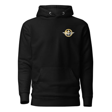 Front view of a hoodie in Black. A small circular emblem sits on the left chest: a gold ring lettered "MIRACULUM IN CAELO NUMQUAM CADET" in white capitals, with a white winged spearhead standing through its centre and swept wings running out to either side.