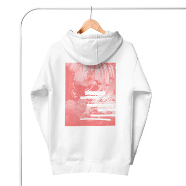 Back view of a hoodie in white. A large coral pink poster panel fills the upper back, printed with a stylized winged figure in soft tonal linework set against a bank of clouds. Horizontal white bars redact most of the text, leaving the words "she, who silences the ether" legible between them, with faint handwritten script and a small circular seal layered underneath. An expressive, editorial, graphic-forward composition.