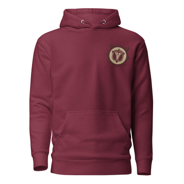 Front view of a solid-colored hoodie. A small, embroidered crest is on the left chest, featuring a central symbol within a circular and star-like frame.