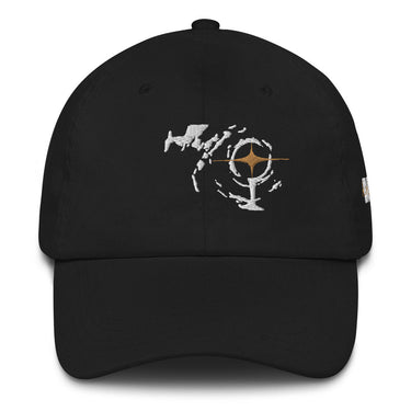 A solid-colored hat. The front features an embroidered graphic with a central, target-like symbol containing a four-pointed star, surrounded by abstract high-contrast shapes.