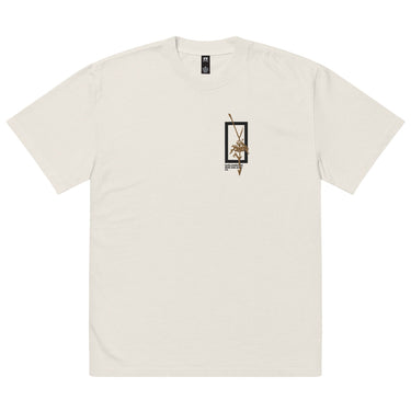 Front view of a solid-colored oversized-tee. A small graphic on the chest features a vertical rectangular frame containing a high-contrast floral illustration and a sword-like shape.