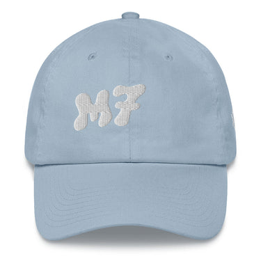 Front view of a solid-colored baseball cap. The front features the letters "M7" embroidered in a large, high-contrast, rounded font with a linear texture.