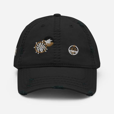 Front view of a solid-colored, distressed hat. The front features two different embroidered circular emblems with abstract patterns.
