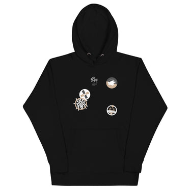 Front view of a solid-colored hoodie. The chest features a small signature and four different circular emblems, each containing a unique high-contrast, abstract pattern.