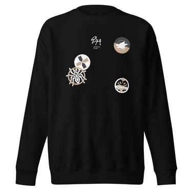 Front view of a solid-colored sweatshirt. The chest features a small signature and four different circular emblems, each containing a unique high-contrast, abstract pattern.